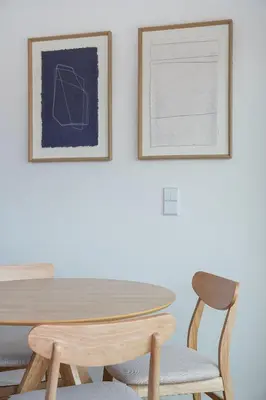 a dining room table and chairs with two pictures on the wall at Spacious Studio Apartment in Porto