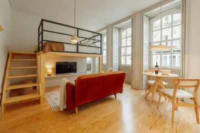 a living room with a loft bed and a table at Deluxe Studio by Hosty in Porto