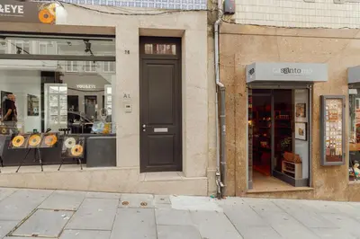 a store front with a black door on a street at Deluxe Studio by Hosty in Porto