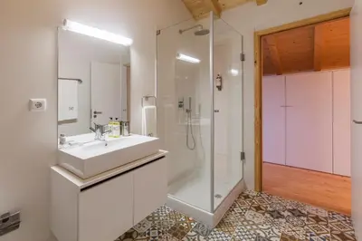 a bathroom with a white sink and a shower at BO - Marquês Apartments in Porto