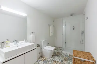a bathroom with a sink and a toilet and a shower at BO - Marquês Apartments in Porto