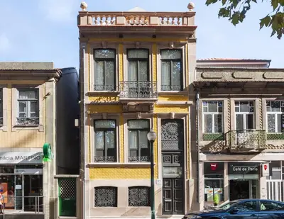 a building on a street with a car in front at BO - Marquês Apartments in Porto