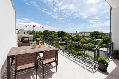 a patio with a table and chairs on a balcony at BO - Marquês Apartments in Porto