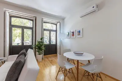 a living room with a white couch and a table at BO - Marquês Apartments in Porto