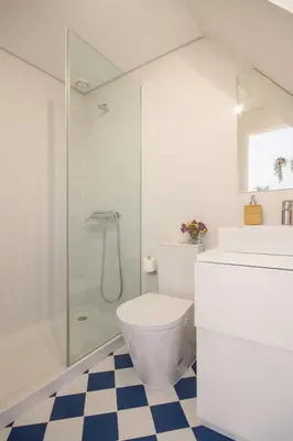 a bathroom with a toilet and a glass shower at Porto Pacific - Almeida Garrett - estúdio a 5 minutos da Ribeira in Porto