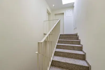 a staircase in a house with white walls and a stair case at GuestReady - Peaceful haven in Porto in Porto