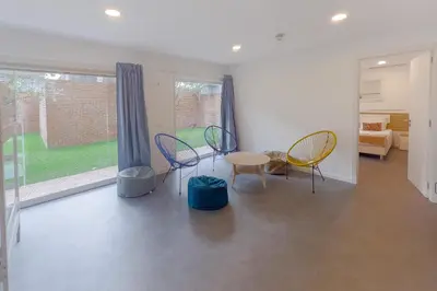 a room with chairs and a table and a window at Magnolia - Exclusive Garden Apartment in Porto