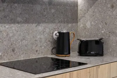 a coffee pot and a toaster on a kitchen counter at Magnolia - Exclusive Garden Apartment in Porto