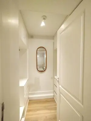 a hallway with a mirror and a white door at Elegant duplex, WiFi, Porto center in Porto