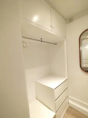 a walk in closet with white shelves and a mirror at Elegant duplex, WiFi, Porto center in Porto