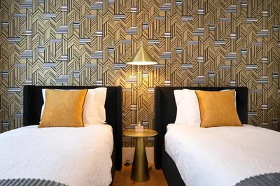 two beds sitting next to each other in a room at Bonjardim Signature Apartment 4B in Porto