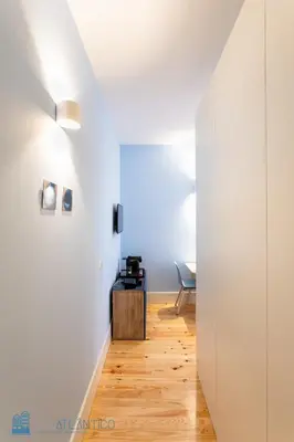 a hallway with white walls and a wooden floor at Blu Constellation - Santa Catarina in Porto