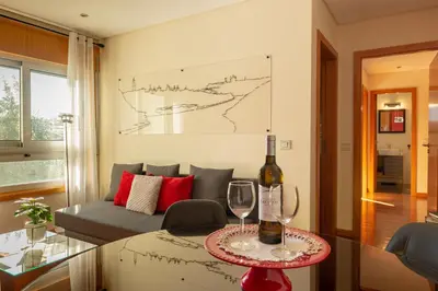 a living room with a couch and a table with wine glasses at Francos Relaxing Apartment by the metro in Porto