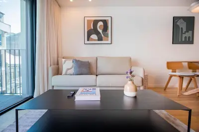 a living room with a couch and a table at Aires Ornelas Gem, City Escape with Private Parking in Porto