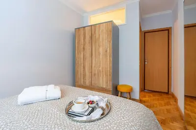 a room with a bed with a plate with a cup at Light-Filled Cedofeita Apt by HostWise in Porto