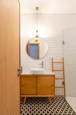 a bathroom with a sink and a mirror at Light-Filled Cedofeita Apt by HostWise in Porto