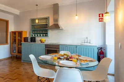 a kitchen with a table with food on it at Light-Filled Cedofeita Apt by HostWise in Porto