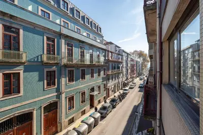 a city street with cars parked on the side of a building at Light-Filled Cedofeita Apt by HostWise in Porto