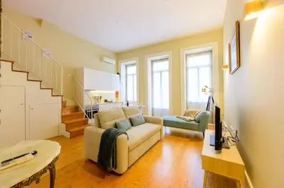 a living room with a couch and a chair at Photography Apartments in Porto