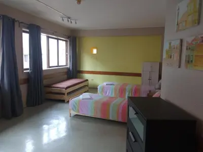 a bedroom with two beds and a tv in it at Porto Central Hostel in Porto