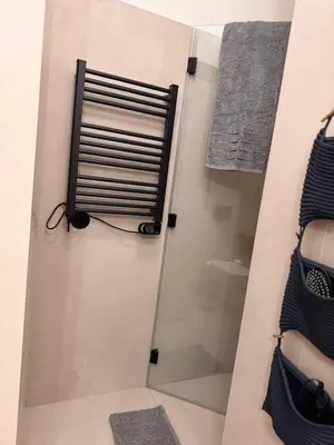 a shower with a glass door in a bathroom at Bonfim cozy apartment Porto in Porto