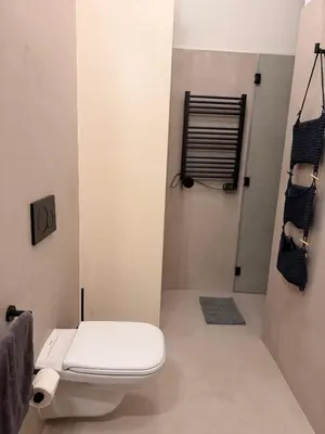 a bathroom with a white toilet and a shower at Bonfim cozy apartment Porto in Porto