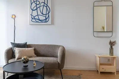 a living room with a couch and a table at Studio Apartment Torrinha in Porto