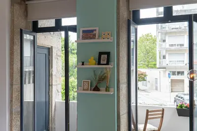 a room with a blue wall with shelves at Studio Apartment Torrinha in Porto