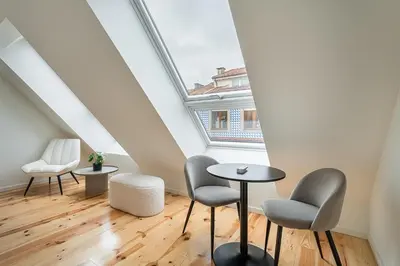 a room with two chairs and a table in a attic at GuestReady - A fantastic home in Porto in Porto