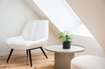 a white chair and a table in a attic at GuestReady - A fantastic home in Porto in Porto
