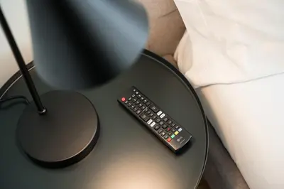 a remote control sitting on a table next to a lamp at GuestReady - A fantastic home in Porto in Porto