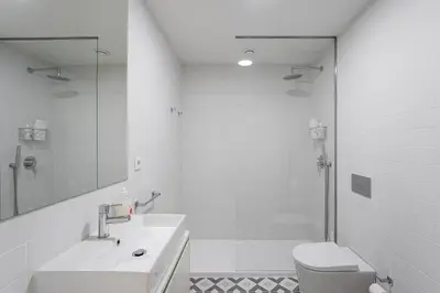 a bathroom with a sink and a toilet and a shower at GuestReady - A fantastic home in Porto in Porto