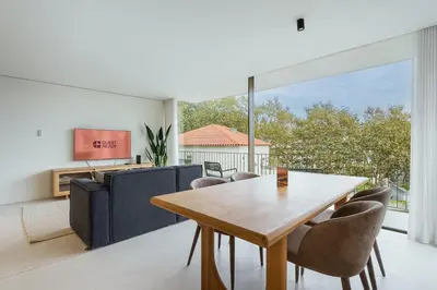 a dining room with a wooden table and chairs at GuestReady - DPV Residences in Porto
