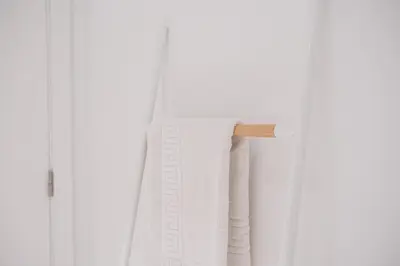 a white towel hanging on a curtain rod at GuestReady - One perfect home near Marquês in Porto