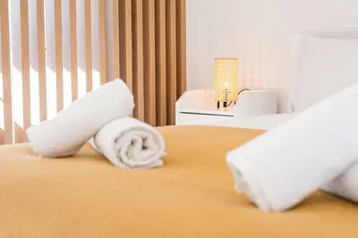 a hotel room with a bed with towels on it at GuestReady - One perfect home near Marquês in Porto