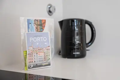 a coffee mug and a book next to a cup at GuestReady - One perfect home near Marquês in Porto