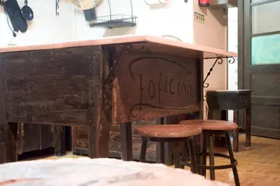 a bar with stools under a counter in a room at A Oficina do Costa in Vila Nova de Gaia