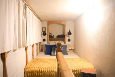 a bedroom with two beds and a mirror at A Oficina do Costa in Vila Nova de Gaia