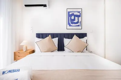 a bedroom with a large white bed with pillows at Povoa Terrace, A Curated Escape with Large Balcony in Porto