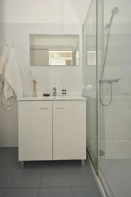 a white bathroom with a sink and a shower at Art & City in Porto
