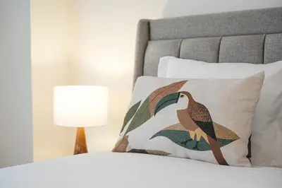 a bed with a pillow with a bird on it at GuestReady - Porto stay with outdoor charm in Porto