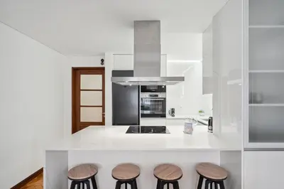 a kitchen with a counter with four stools at GuestReady - Porto stay with outdoor charm in Porto