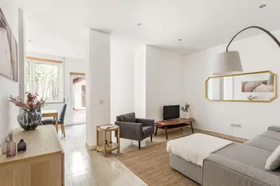 a white living room with a couch and a chair at GuestReady - Central & spacious apartment in Porto in Porto