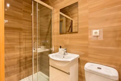 a bathroom with a toilet and a sink and a shower at GuestReady - Central & spacious apartment in Porto in Porto