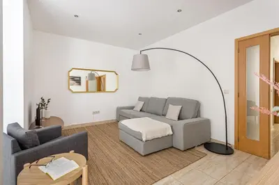 a living room with a couch and a floor lamp at GuestReady - Central & spacious apartment in Porto in Porto