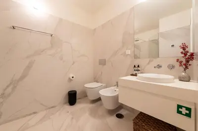 a white bathroom with a toilet and a sink at Almada 559 - Almeida Garrett Nook by Lisbeyond in Porto