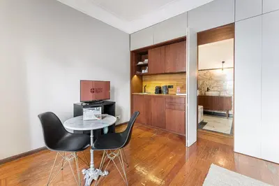 a kitchen and dining room with a table and chairs at GuestReady - Rivoli Studio in Porto