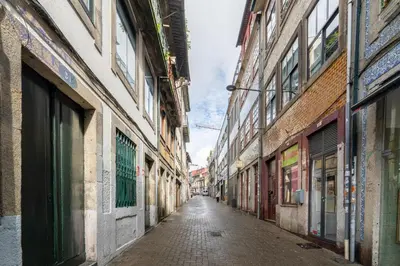an empty alley in an old city with buildings at Microloft in the heart of Porto in Porto
