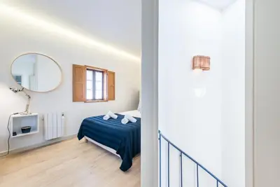 a bedroom with a bed and a mirror at GuestReady - Timber-framed luxe stay in Porto