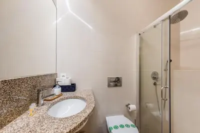 a bathroom with a sink and a shower at GuestReady - Timber-framed luxe stay in Porto